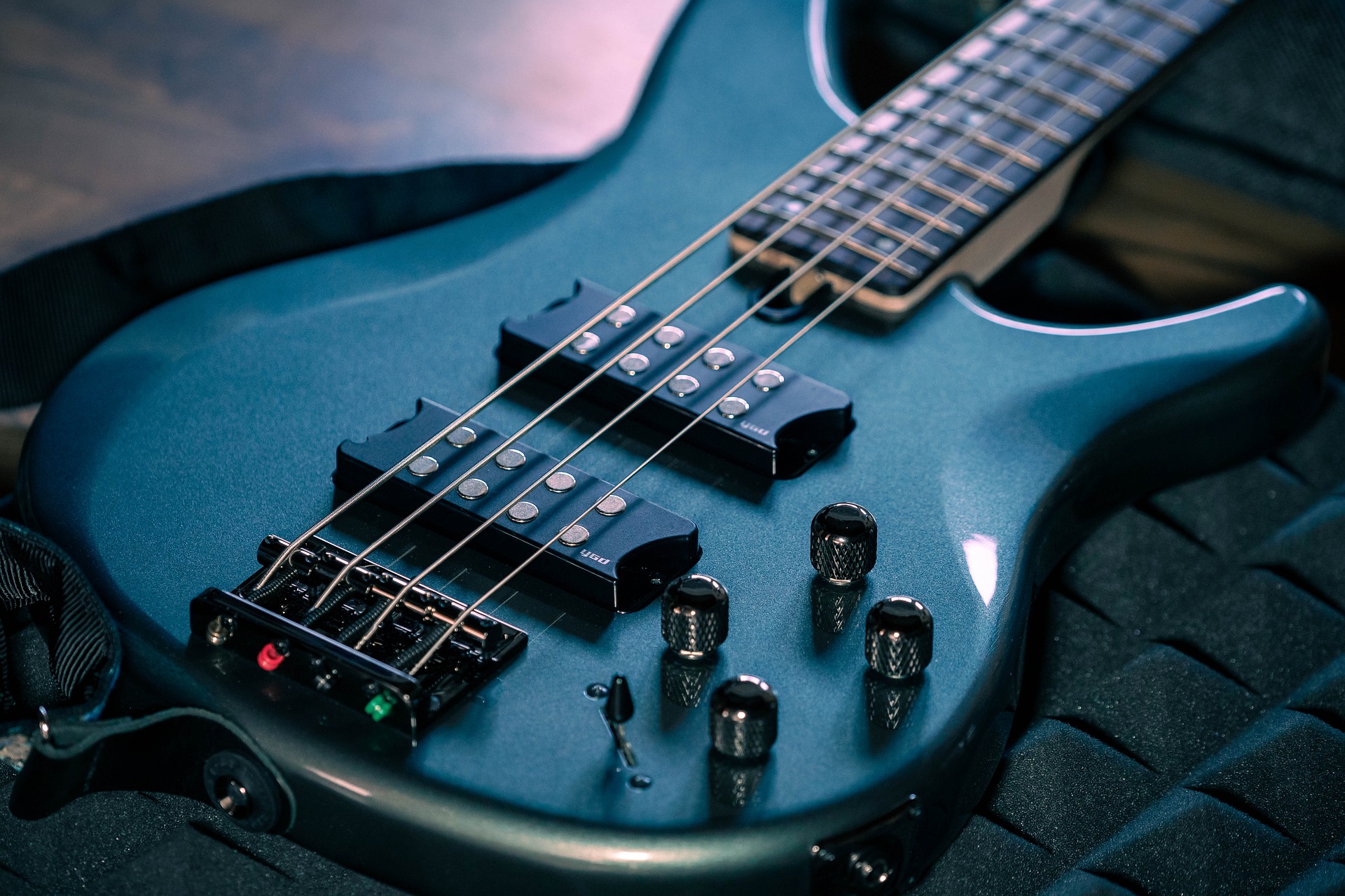 view of pickups on blue electric bass